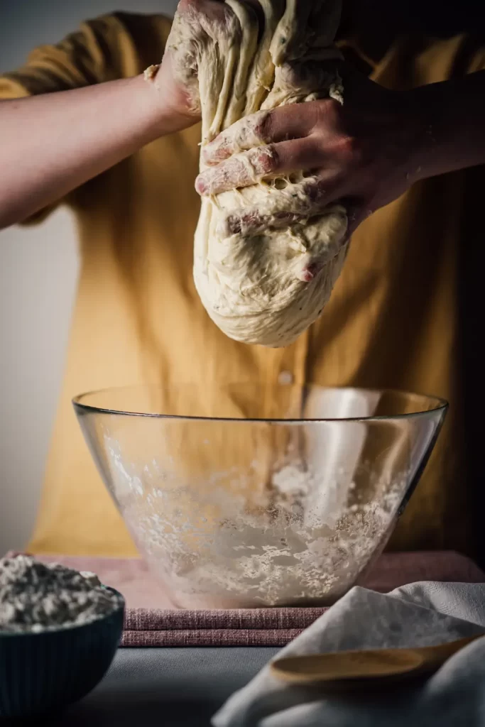 Person mixing sourdough before baking