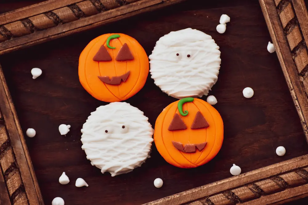 halloween cookies decorated like pumpkins and mummies