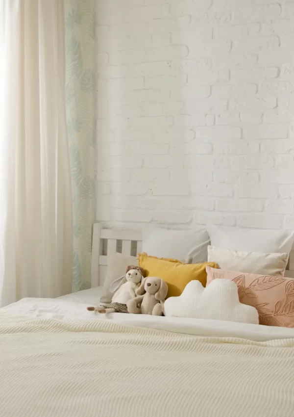bed in apartment with cloud pillow