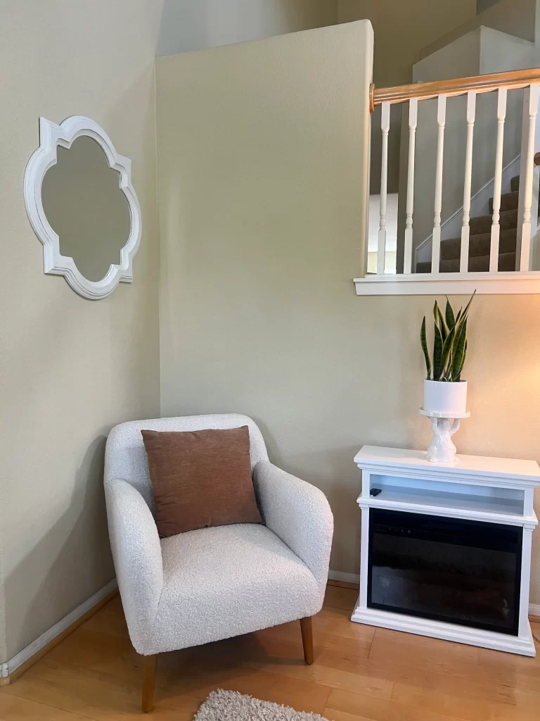 reading nook in corner of room with a boucle chair